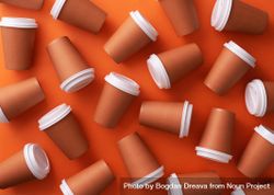 Scattered disposable coffee cups on orange background 41yNN4