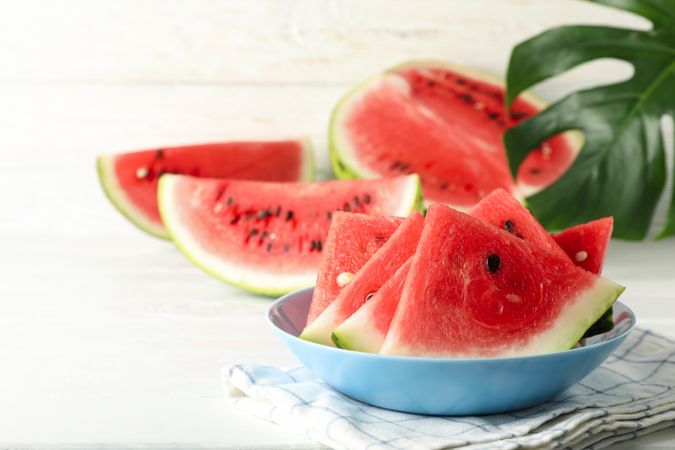 Composition with plate of fresh watermelon on blank wooden background