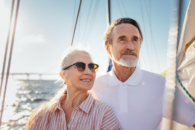 Portrait of two older people looking into the distance on a yacht