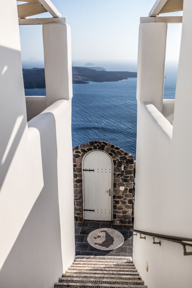 Stairs with gate leading down the Aegean Sea