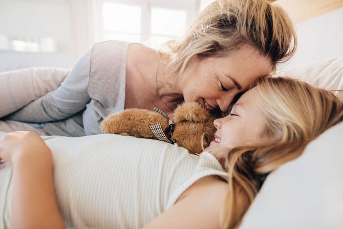 Loving parent being affectionate with daughter