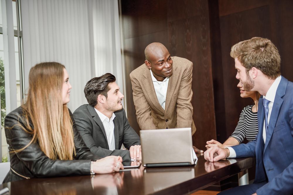 Black male leading his colleagues in a brain storming meeting at work