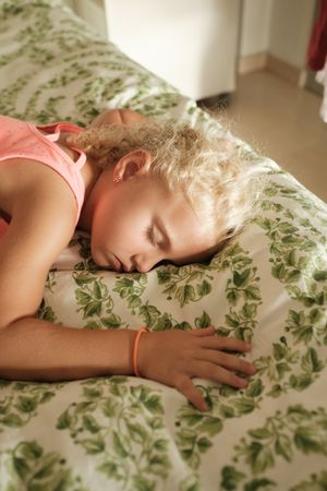 Adorable girl resting in bed