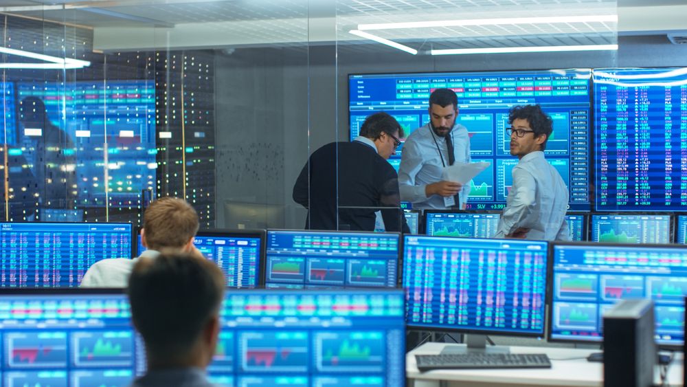 Three Experienced Stock Traders Talking Business, Consulting Documents and Argue About Data.
