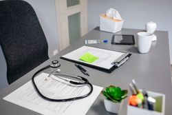 Doctor desk with documents and stethoscope