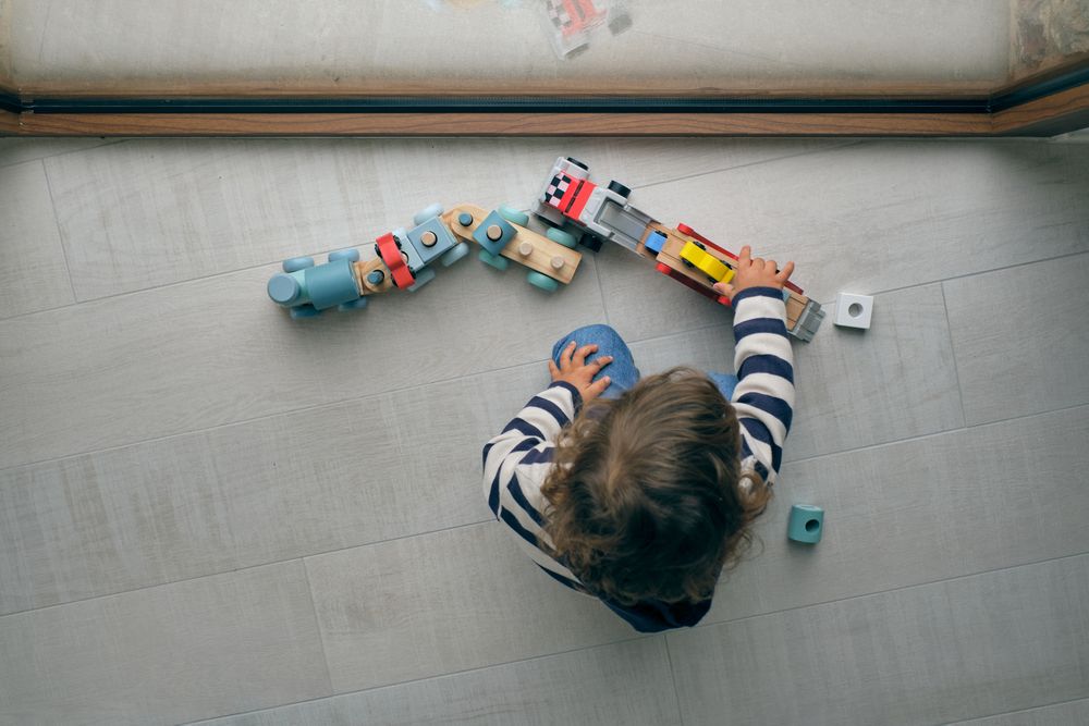 Unrecognizable child playing with toys