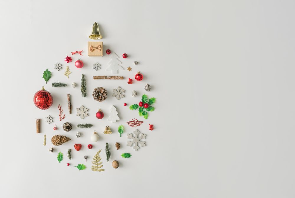 Christmas bauble made of various winter and holiday objects on light paper