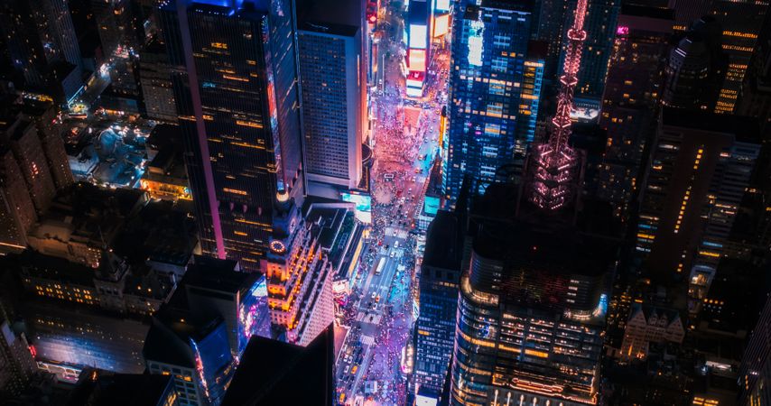 Helicopter Night Tour of New York City Architecture. Illuminated Times Square with Groups of Tourists Enjoying Manhattan Nightlife and Admiring the Landmark with Diverse Advertising Billboards