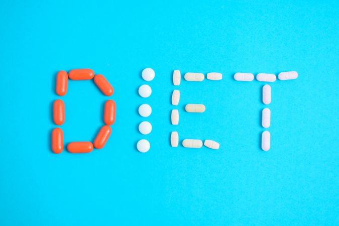Pills spelling the word "DIET" 