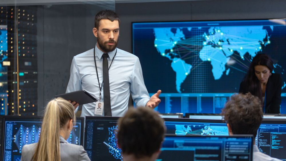 Chief Project Engineer Holds Briefing for a Team of Scientists that are Building Machine Learning System.