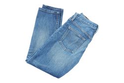 Close-up of folded jeans, isolated on light background