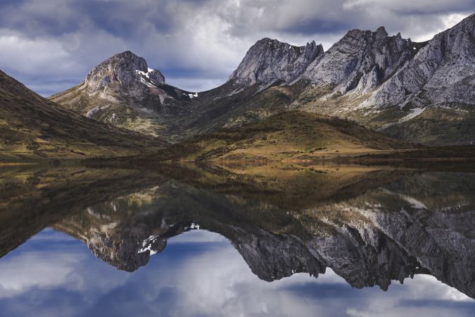 Cloudy sky over calm lake and mountains