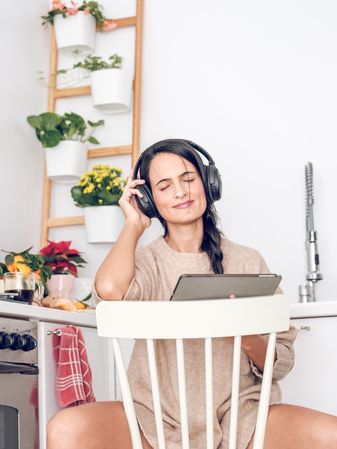 Happy woman listening to music in headphones