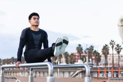 Sportsman exercising on parallel bars