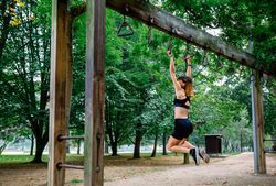 Woman doing monkey exercises on rings