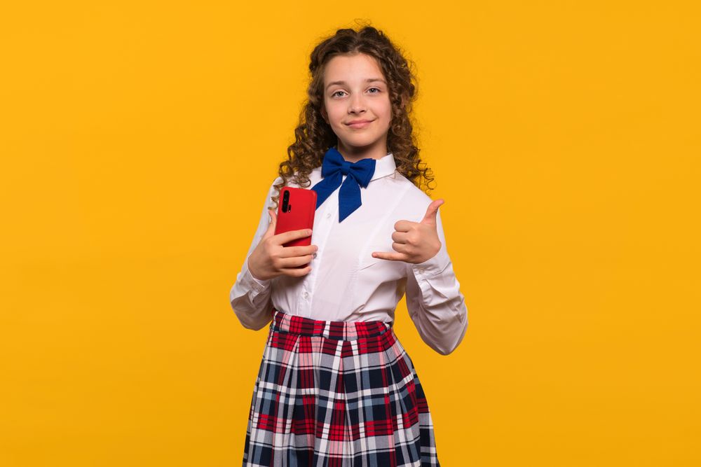 Girl with red smartphone making call me gesture