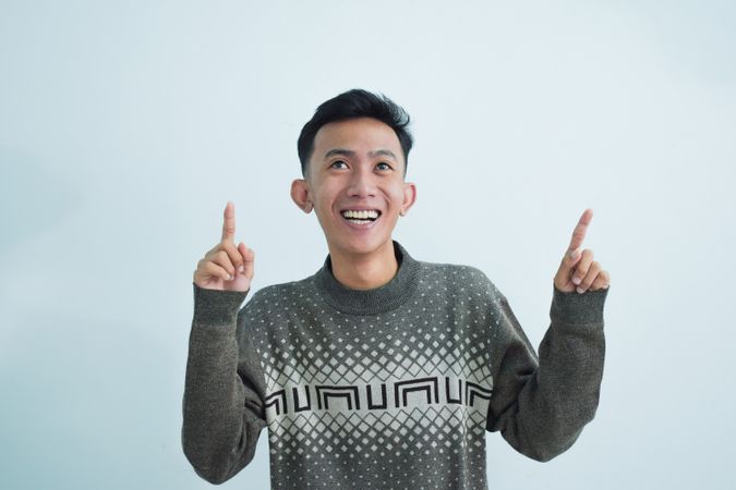 Asian man showing pointing gesture