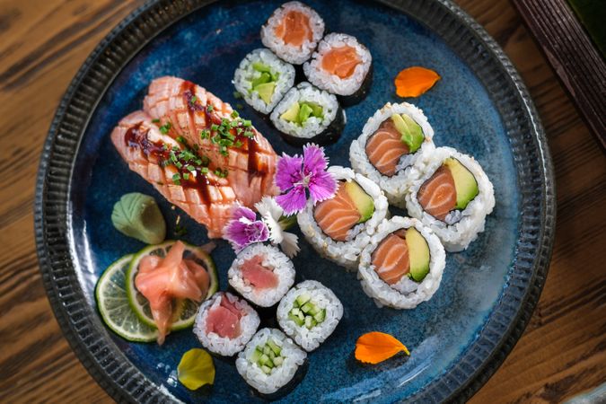 Plate with assorted sushi served with wasabi and ginger
