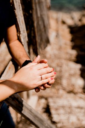 Tender lovers holding hands in sunlight