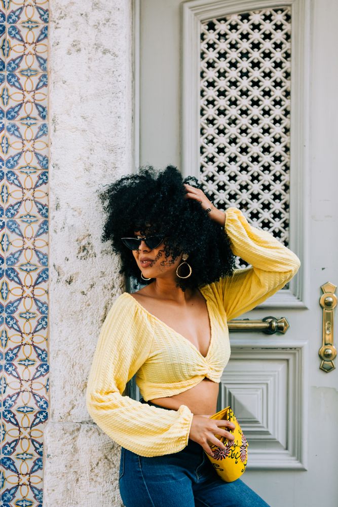 Fashionable Black female by gray door
