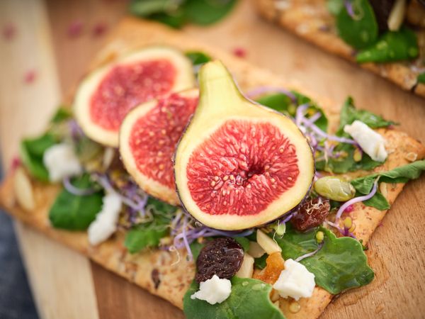 Fresh colorful figs served on wooden surface