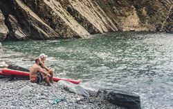 Couple with paddleboards looking at wonderful sea