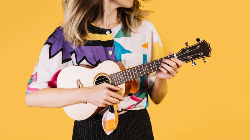 Blonde woman playing ukulele