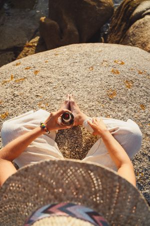 Woman relaxing and drinking beer at beach