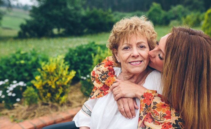 Older woman in a wheelchair with her daughter