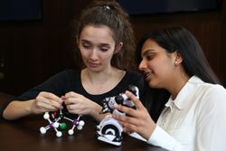 Two women with molecule model