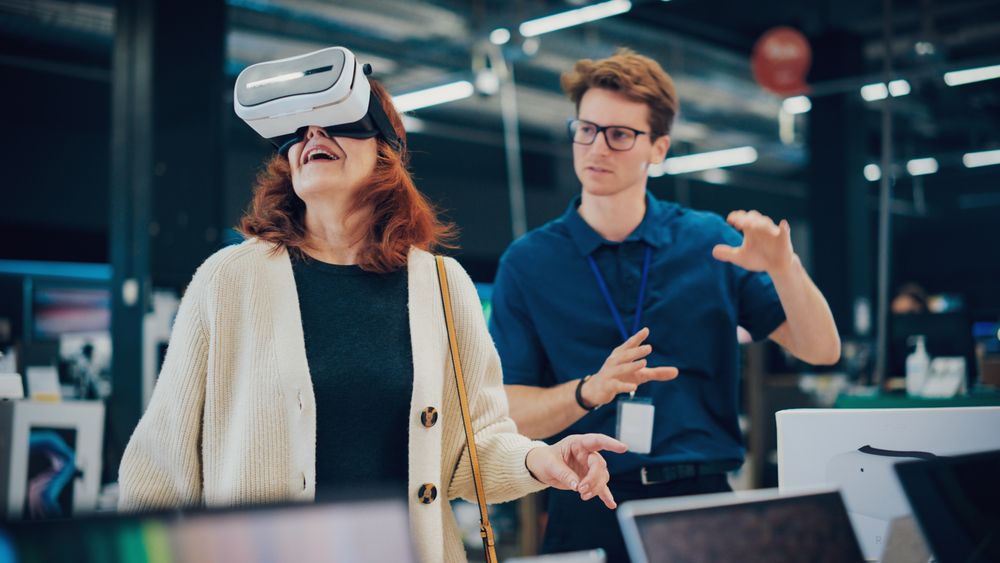 Shopper Explores Advanced Technology with Professional Assistance