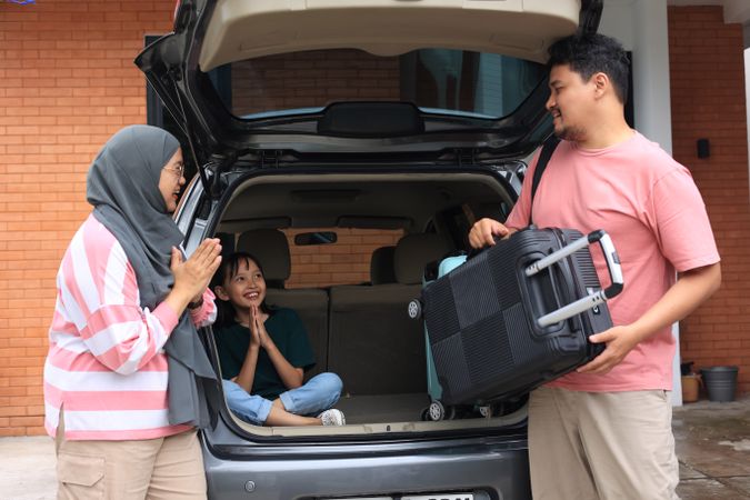 Asian Muslim Family with Kids Going on Mudik Road Trip Back Home During Eid Mubarak Celebration