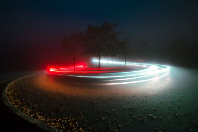 View of abstract shines on road between fog at night