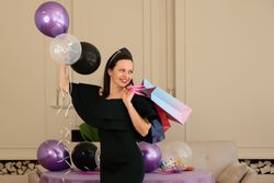 Woman in dress holding gift bag