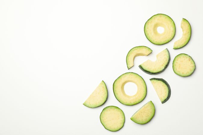 Flat lay with avocado slices on plain background, top view