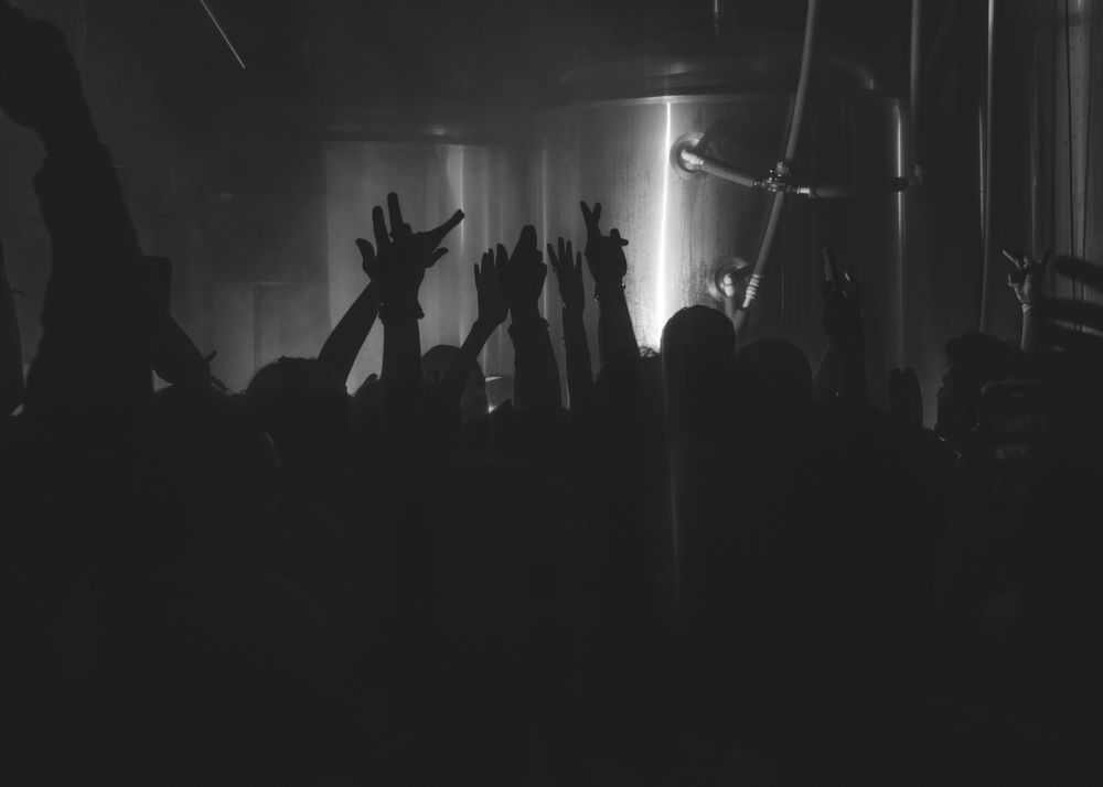 London, England, United Kingdom - Nov 9, 2022: dark shot of hands up on the dance floor