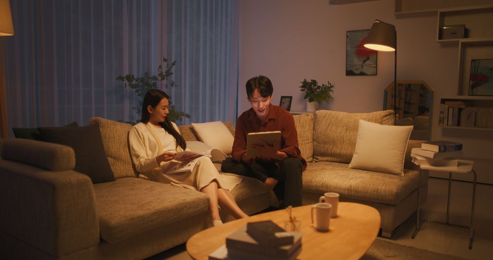 South Korean Couple Sitting on a Comfortable Modern Couch.