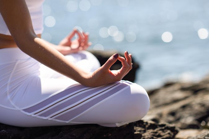 Close up of woman meditating at the beach