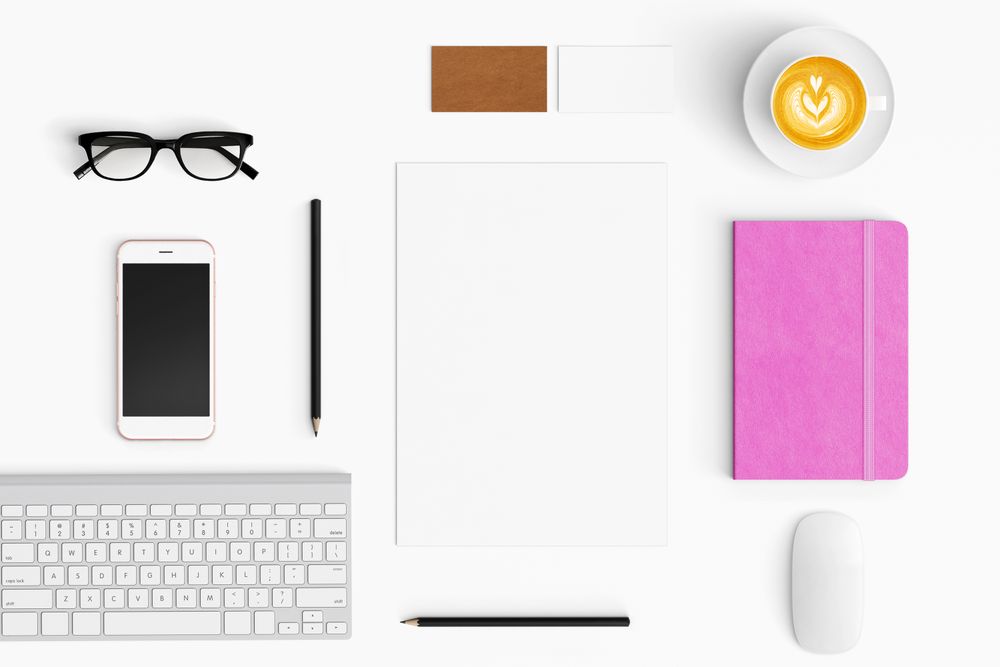Modern workspace with coffee cup, smartphone, paper, tablet and notebook copy space