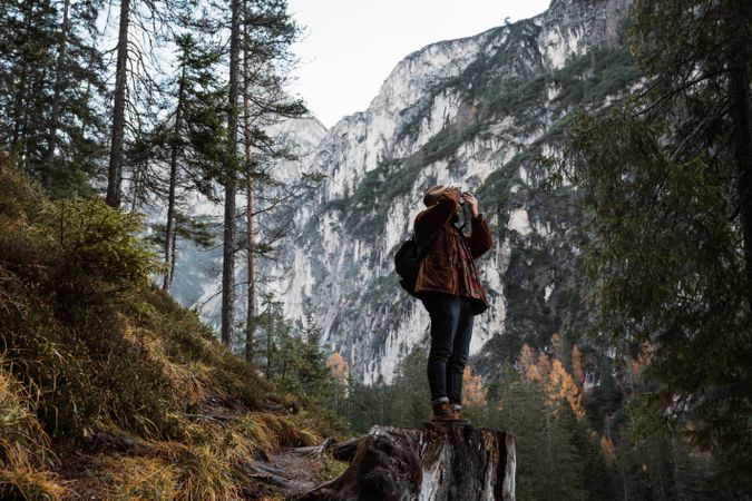 Man in amazing landscape in a autumn forest at the mountains