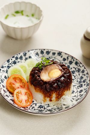 Indonesian breakfast of soy sauce chicken and rice, vertical