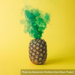 Pineapple with green smoke on bright yellow background 4ARPEb