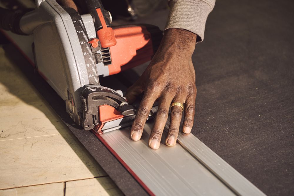 Hands of a Black male designer with saw