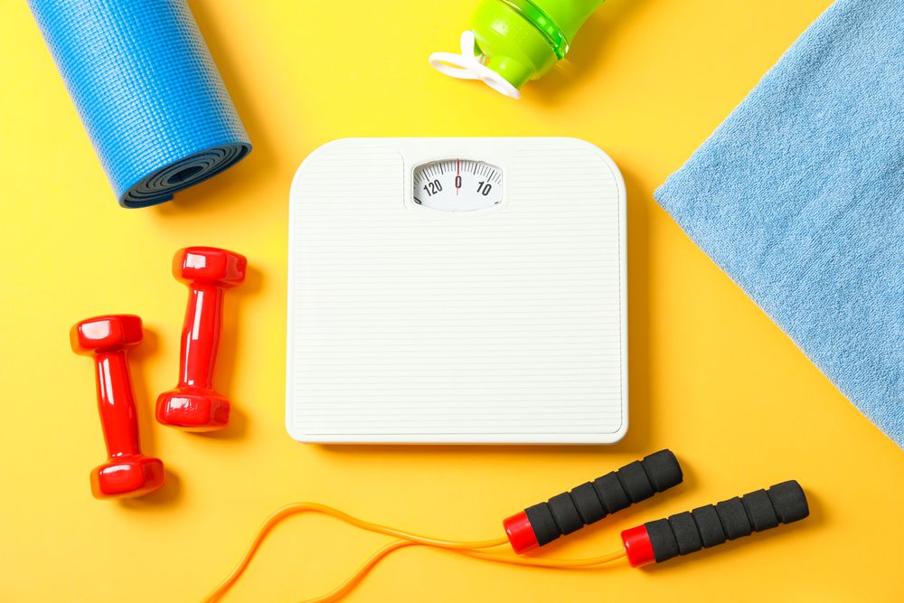 Flat lay composition with healthy lifestyle accessories on color background