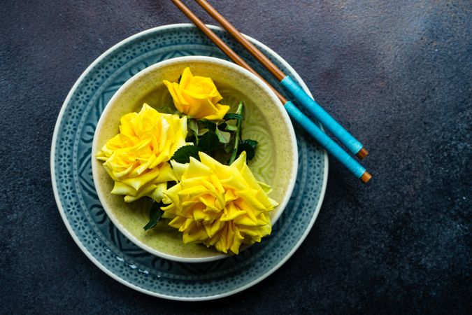 Blue table setting with yellow roses