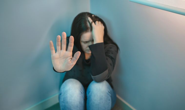 Desperate woman  refusing help with hand