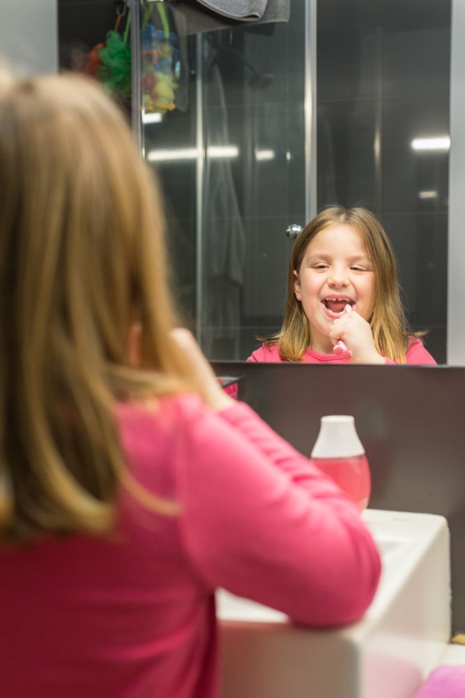 Cute girl brushing her teeth