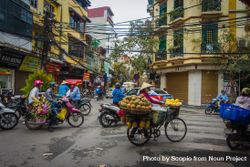 People riding motorbikes and food carts on street of Vietnam 5pKrx0