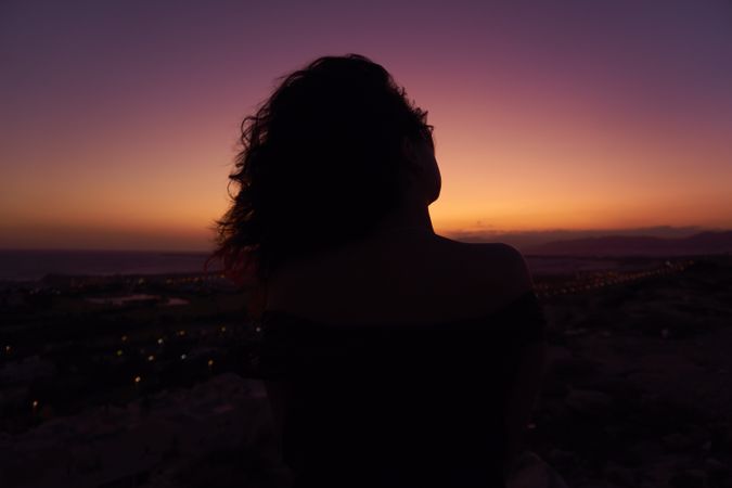 Silhouette of female enjoying picturesque sunset