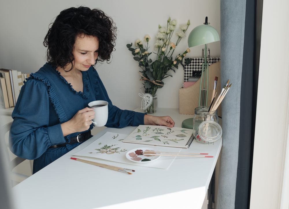 Painter sitting with cup of coffee at work